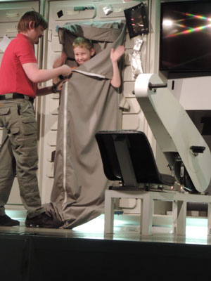 Will gets strapped into an Astronaut sleeping station on the ISS mock up.