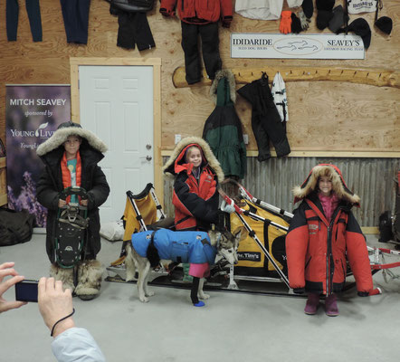 The kids try on the Dog Sledders equipment for the Iditarod Race