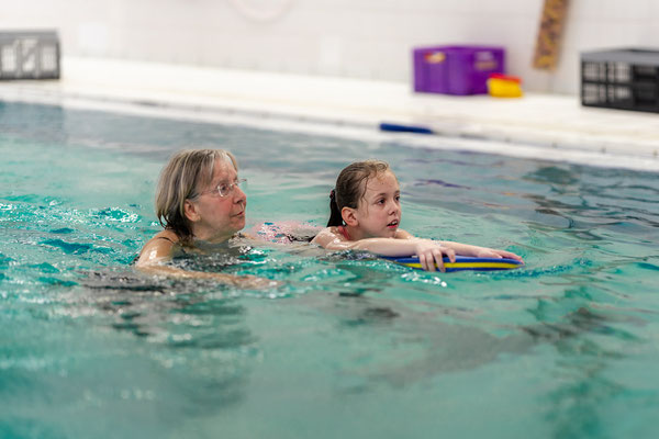 Kind lernt Schwimmen mit Schwimmbrett in der Delfine-Gruppe des BSV Achim
