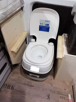 Zum Benutzen muss man die Toilette um 90° drehen. Vorher kann man die lose auf dem Rahmen liegende Sitzfläche einfach abnehmen.