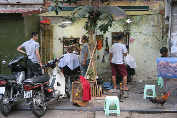 Entre les scooters et les poules, on peut même se faire tailler la barbe ou couper les cheveu 