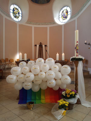 19 am Altar befestigte Luftballons mit den Namen der 19 Kommunionkinder