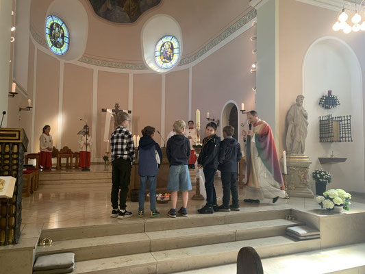 Zur Segnung der Ostereier durch Pfr. Schmitz haben sich fünf Erstkommunionkinder am Altar versammelt