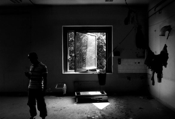 Ibrahim from Bangladeshi looks at mobile phone in the squatted 'Area Ingovernabile' (previously a Minister of Finance offices block) in an outskirt neighbourhood of Rome.Initially occupied by Bangladeshi Dhuumcatu association, it is a home for immigrants.