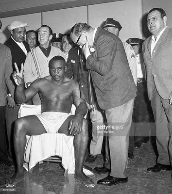 Sonny Liston holding up two fingers, gesturing second round knockout for his opponenet Cassius Clay, during his medical check prio the fight, Miami, USA (Harry Benson/Contour by Getty Images)