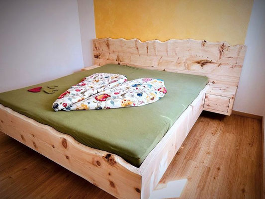 Modernes Zirbenbett mit rustikalen Kopfteil aus Zirbe – Handarbeit aus Massivholz