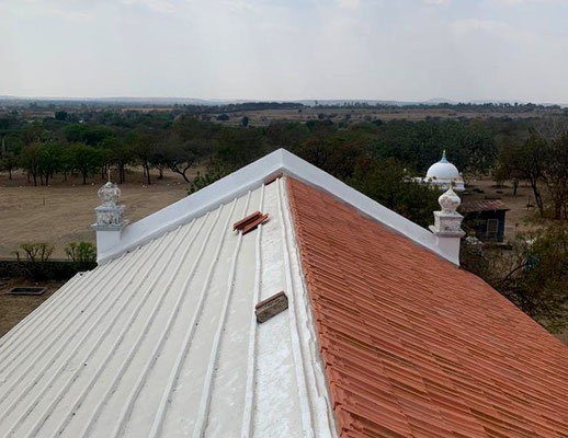 Mangalore tiles being placed over the waterproof membrane on the roof of the Meher Retreat Building