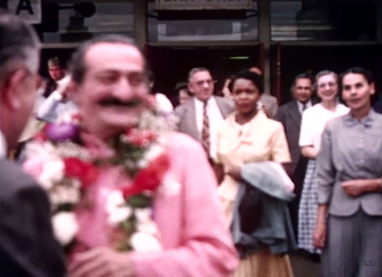 Idlewild Airport : Meher Baba greeted by his entourage outside the airport. Beryl Williams ( L ) & Ella Winterfeldt ( R ) look on. Image captured from a film by Anthony Zois