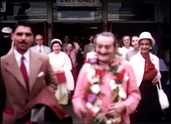 Idlewild Airport : Meher Baba greeted by his entourage outside the airport with Eruch Jessawala. Jean Shaw ( L ) look on. Image captured by Anthony Zois from a film by Sufism Reoriented.