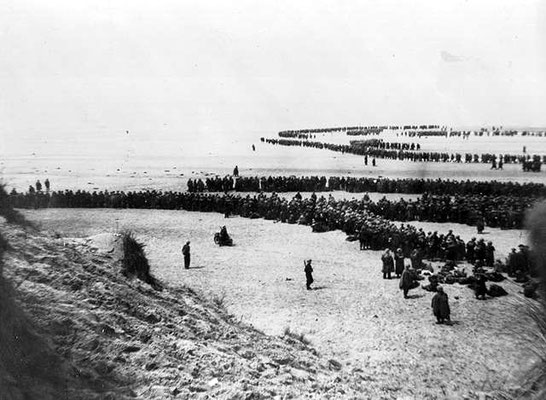 Allied troops gathering on the beaches to be evacuated