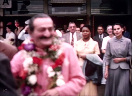 Idlewild Airport : Meher Baba greeted by his entourage outside the airport. Beryl Williams ( L ) & Ella Winterfeldt ( R ) look on. Image captured from a film by Anthony Zois