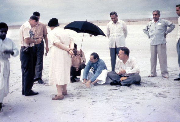 Meher Baba on Center Beach ( Arcadia Beach ) at Myrtle Beach, Sc. Eruch Jessawala holding the umbrella and Lud Dimpfl looking on. Meherjee Karkaria, Adi K Irani & Don Stevens standing behind. Elizabeth Patterson,Darwin Shaw & Beryl Williams on far left.