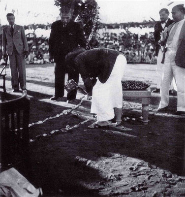 17th December 1939 - Meher Baba breaking ground at the Foundation. Bhyrumshaw D. Jessawala "Papa" and Kaka Baria looking on.