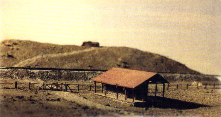 Model shows the Post Office (women's quarters) the railwat crossing & Meherbad Hill.