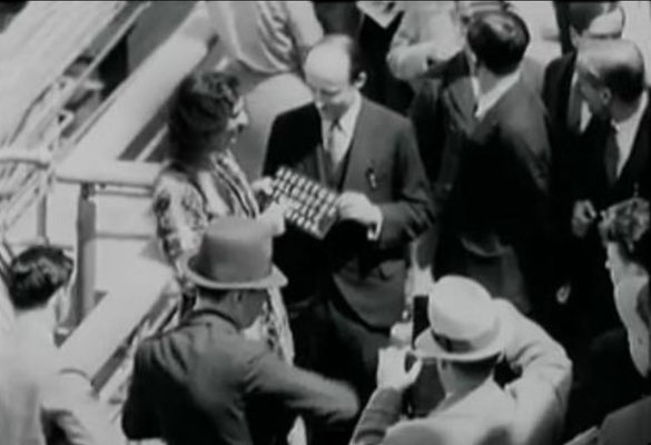 Meher Baba with his men mandali & Meredith Starr holding his board for the press prior to docking in New York