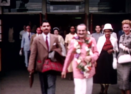 Idlewild Airport : Meher Baba outside the airport with Eruch Jessawala & Marion Florsheim ( R ). Ella Winterfeldt ( behind ) look on. Image captured by Anthony Zois from a film by Sufism Reoriented.