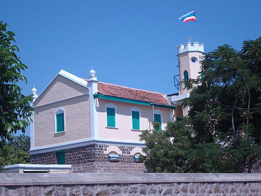 Baba's flag flying at the museum building at Upper Meherabad, India.
