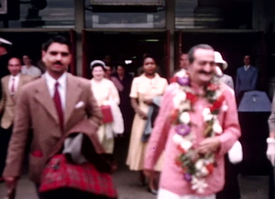 Idlewild Airport : Meher Baba greeted by his entourage outside the airport with Eruch Jessawala. Beryl Williams ( R ) & Jean Shaw ( L ) look on. Image captured by Anthony Zois from a film by Sufism Reoriented.