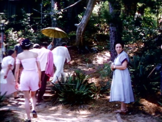 1956 ; Meher Center, Myrtle Beach, SC. ; Meher Baba walking up the steps from the bridge. Annarosa in pink summer outfit & her mother Theresa DiBlasio on the right. The images were captured by Anthony Zois from a film by Sufism Reoriented