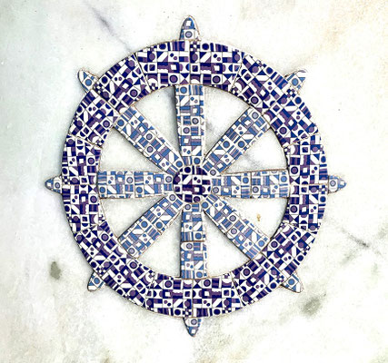 The Dharma Chakra or the Wheel represents the Buddhist faiths
