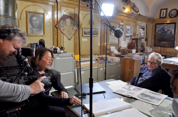 Claudia interviewing a Swiss historian in the video.