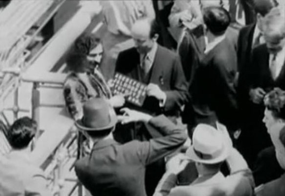 Meher Baba with his men mandali & Meredith Starr holding his board for the press prior to docking in New York