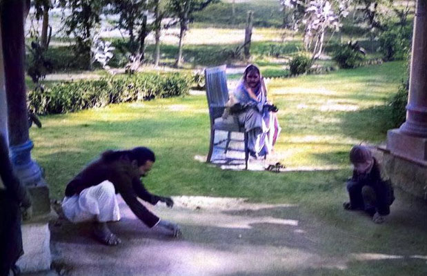 Meher Baba plaing marbles with young Meherwan.