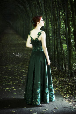 Circle skirt evening dress with hand sewn clover appliques .