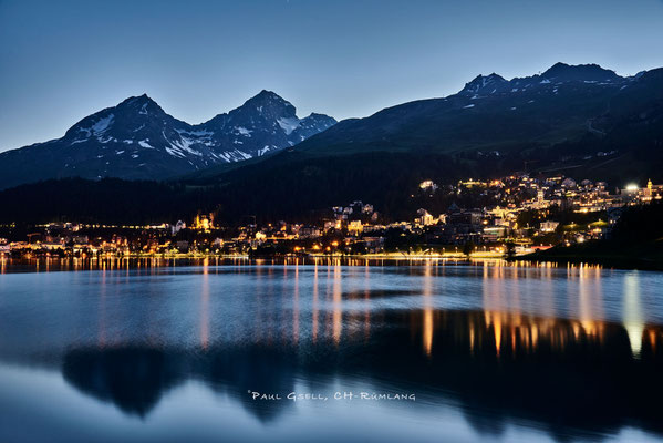 St. Moritz bei Abenddämmerung, Blick auf St. Moritzersee, Lichter von St. Moritz Dorf und die Berge mit Piz Julier und Piz Nair