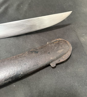 Lame courbe à dos plat et pans creux, portant un poinçon au faisceau de licteur