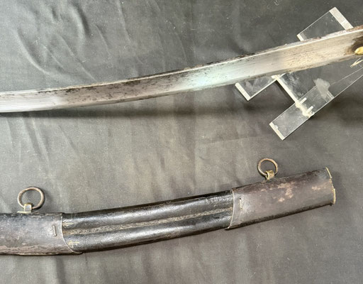 Lame courbe à dos plat et pans creux, portant un poinçon au faisceau de licteur