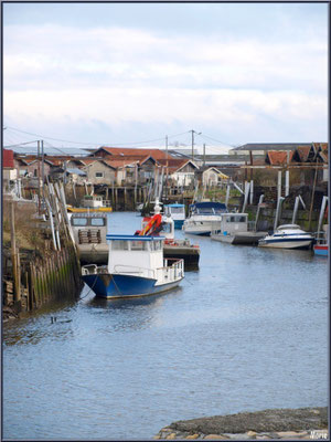 Un chenal du port, bateaux et cabanes 
