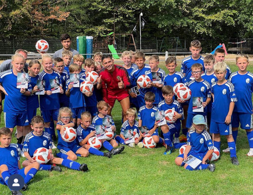 Football team group photo after birthday match event on professional field