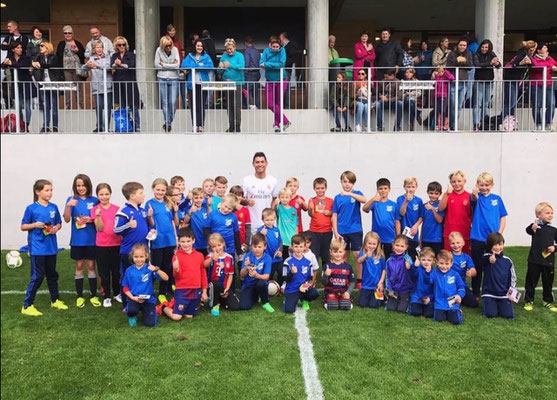 Mixed group of children in jerseys after a fun football birthday event