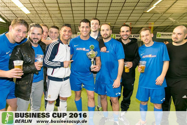 Gruppenfoto beim Business Cup 2016 Berlin: Team in blauen Trikots präsentiert den Pokal.