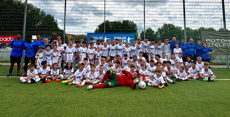 Football team group photo after birthday match event on professional field
