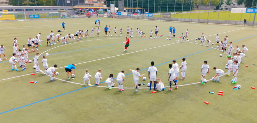 Large football training circle with children participating in warm-up games