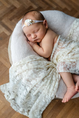 Neugeborenes Baby liegt geborgen auf der Decke im Wochenbett in Leipzig