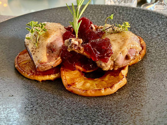 Roasted pigeons over a bed of caramelized potatoes