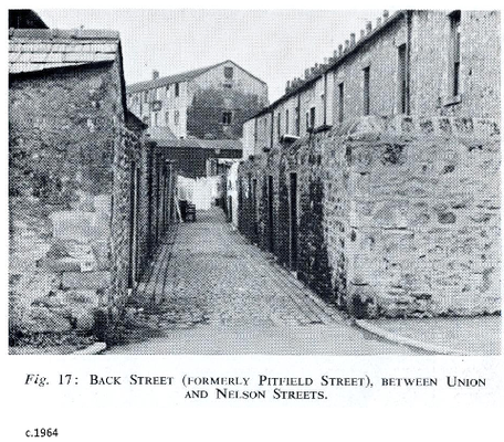 Back street (formerly Pitfield Street) between Union and Nelson streets, mill in background. c1964
