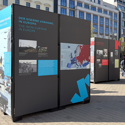 Ausstellung “Durch den Eisernen Vorhang“: Die Outdoor Ausstellung am ehemaligen Grenzübergang Checkpoint Charlie thematisiert die historische Bedeutung dises Ortes.