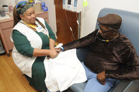 Angie's Spa massage therapist massages the hands of a patient receiving cancer treatment UFL Jacksonville.