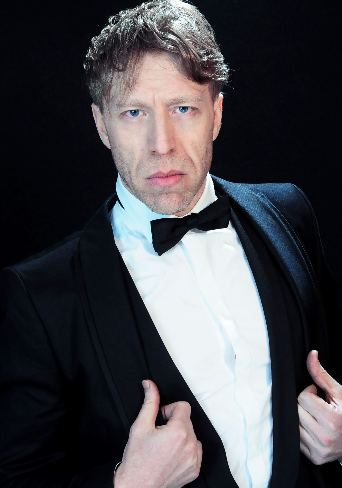 Ottaviano Blitch, Italian actor and performer, elegant portrait in a tuxedo and bow tie against a dark background, attore performer italiano ritratto elegante smoking