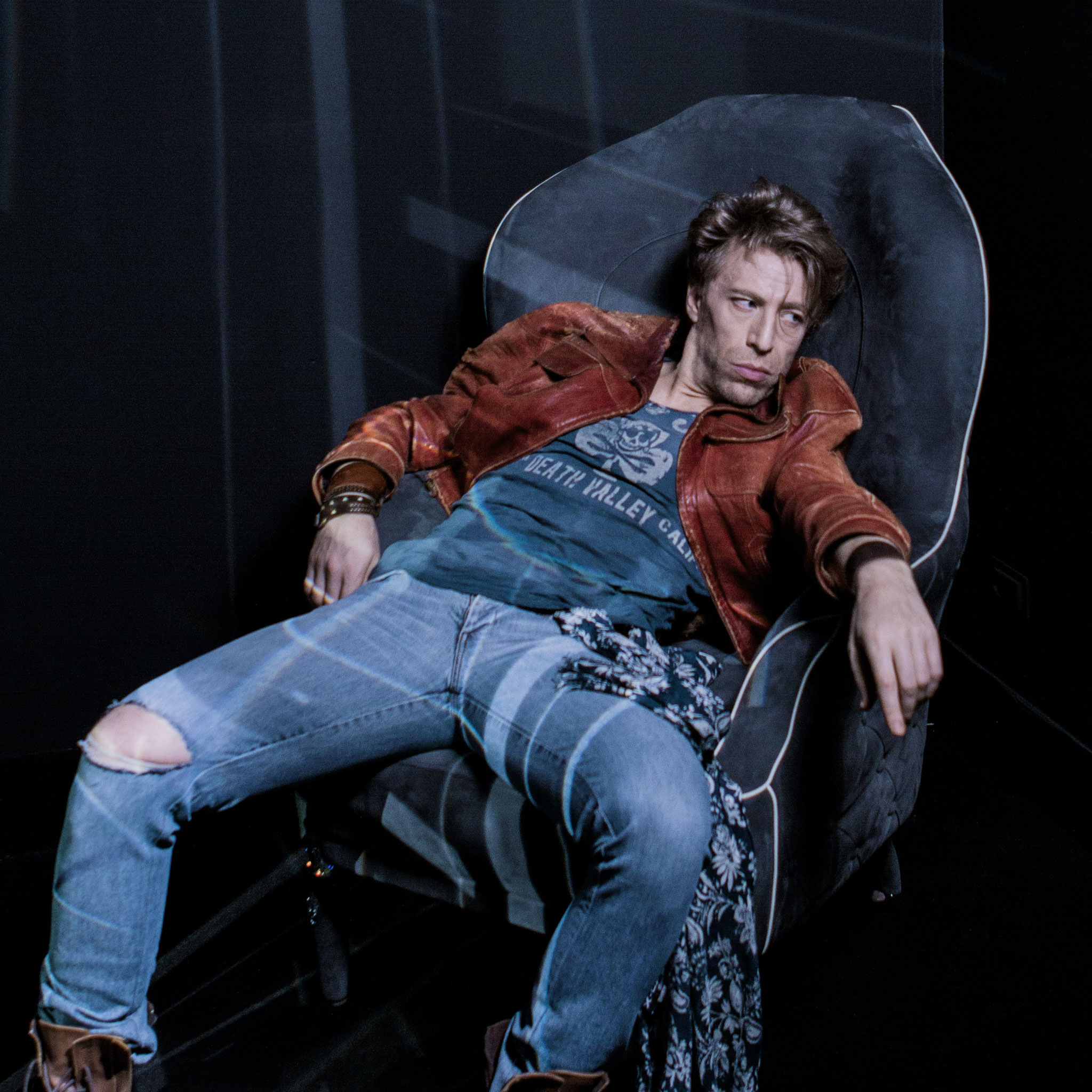 Ottaviano Blitch, Italian actor and performer, casual editorial fashion portrait seated in a bomber jacket and ripped jeans, attore performer italiano ritratto moda casual editoriale