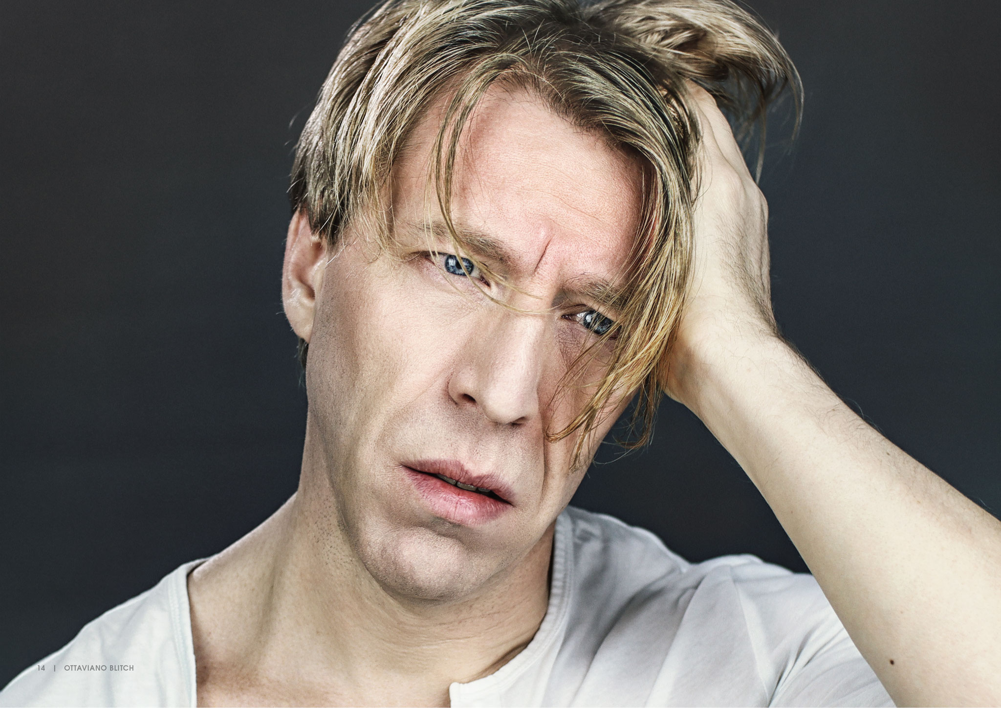 Ottaviano Blitch, actor and performer, intense editorial portrait with hand through his hair in a white shirt, attore performer ritratto editoriale intenso