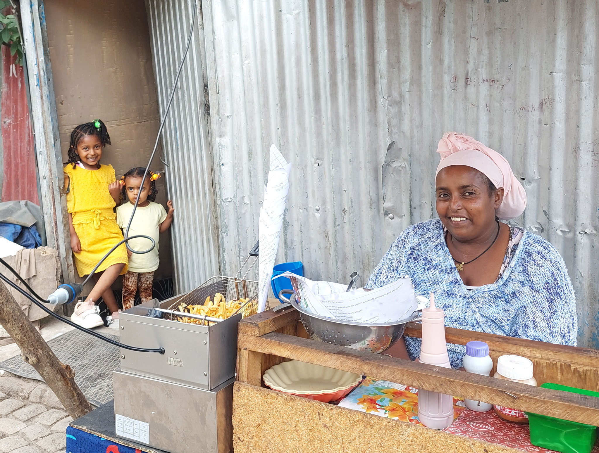 Zenabu has opened a takeaway at home. She uses a deep fryer to prepare samosas and chips and offers sandwiches.