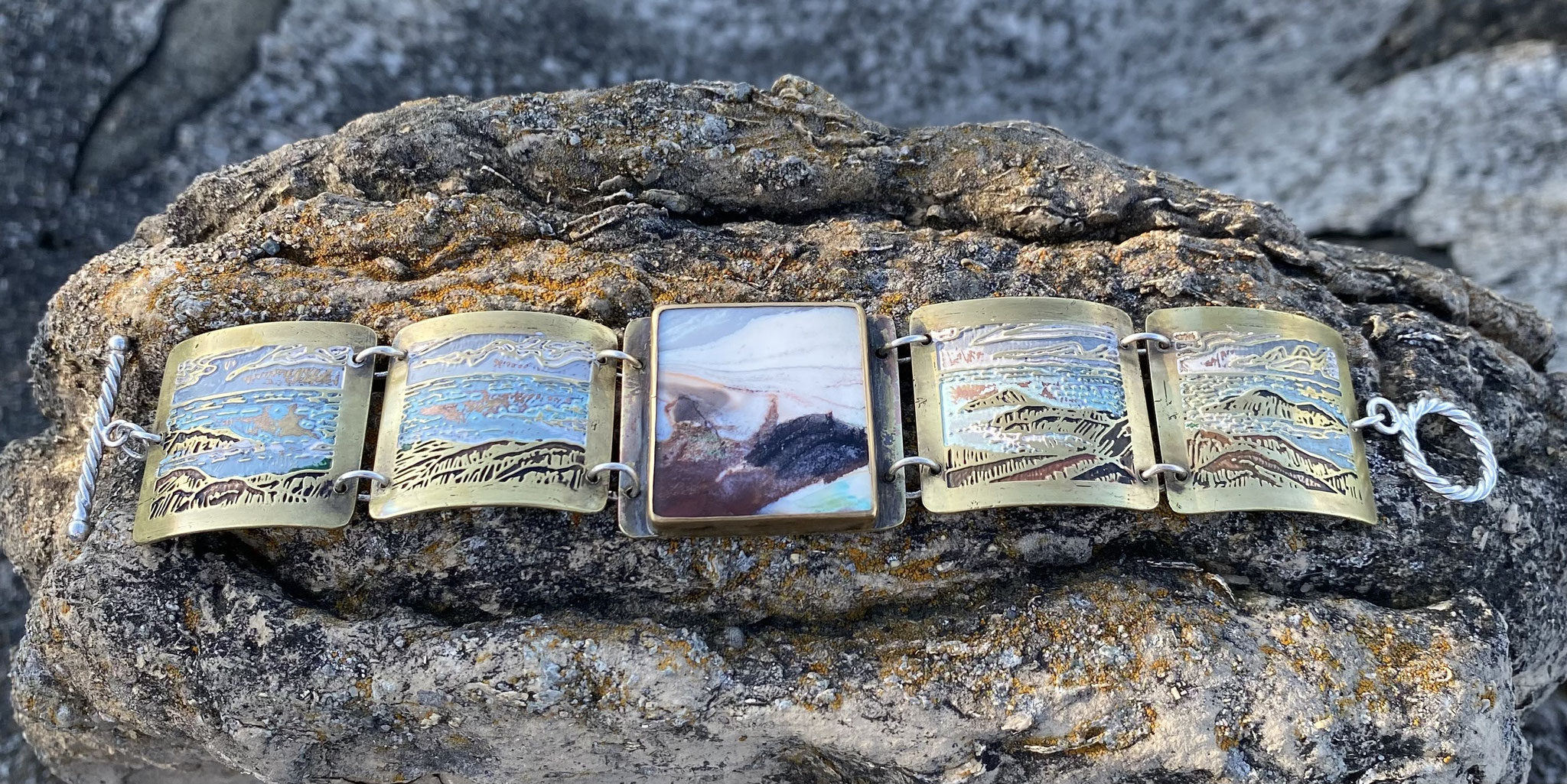 Lake Superior Lake Superior” - hand-drawn and etched brass, opalized, petrified wood.bracelet by Vicki Jasperse