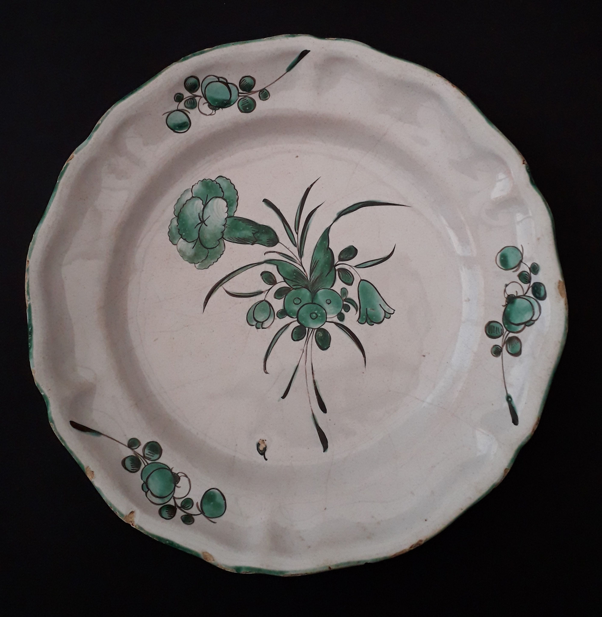 Assiette décor vert de cuivre - Diam. 22 : assiette de forme argenterie avec un bouquet à l'œillet au centre et des brindilles fleuries sur l'aile, le tout en camaïeu vert, plus rare que la polychromie. 