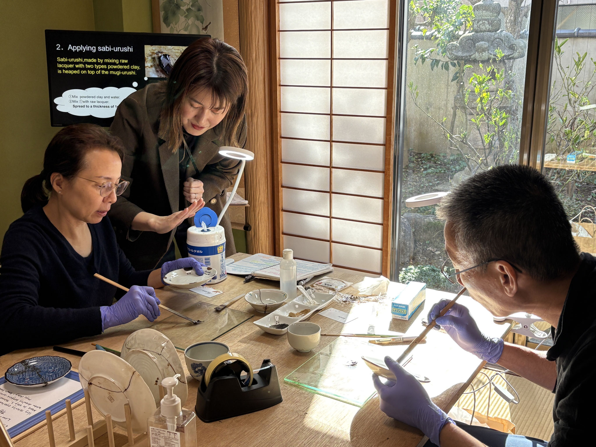 Kintsugi artist guiding guests at a traditional Kintsugi workshop in Kanazawa, Japan