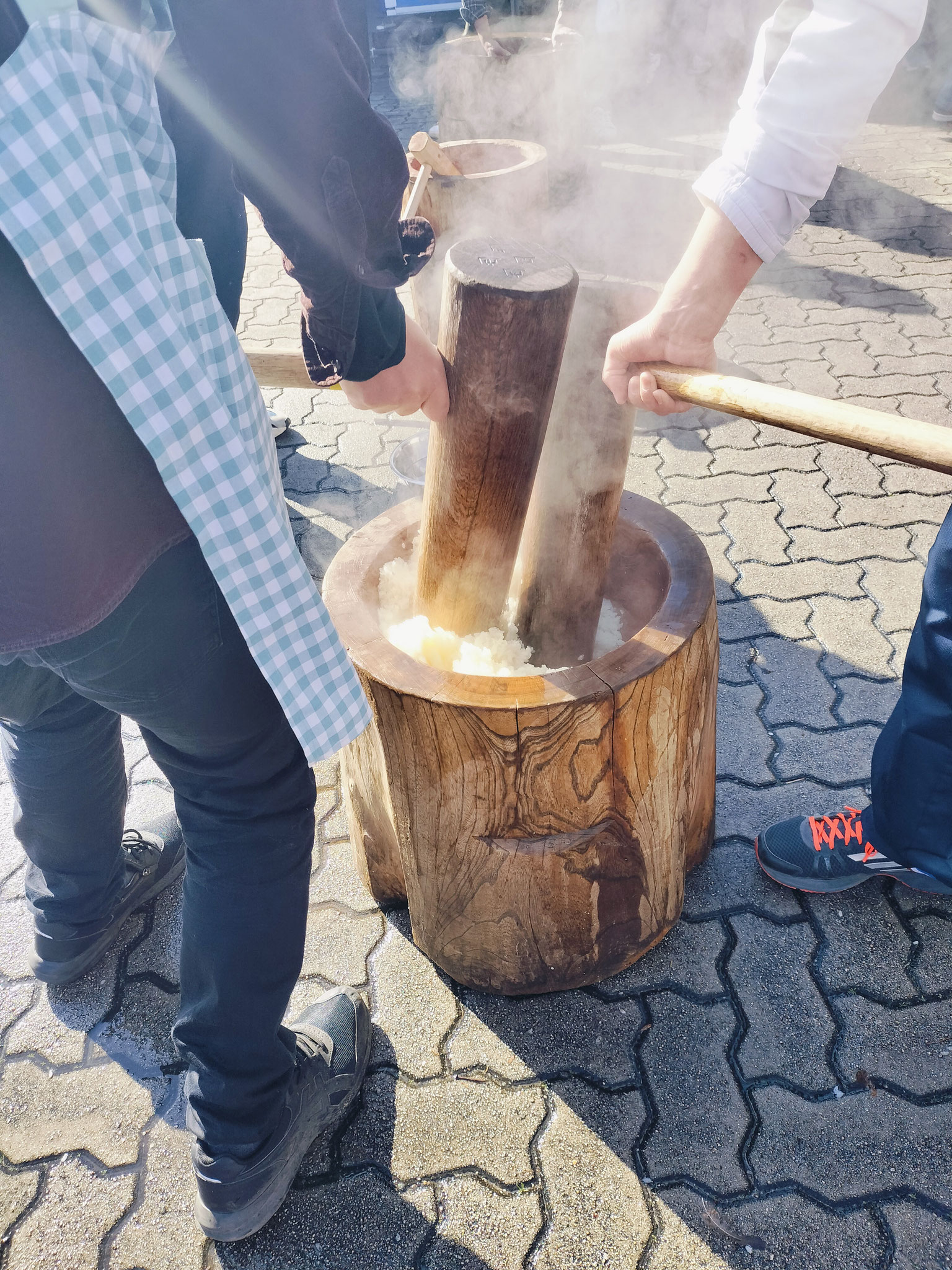せいろで蒸したもち米を、杵（きね）と臼（うす）を使って粘り気が出るようについていきます